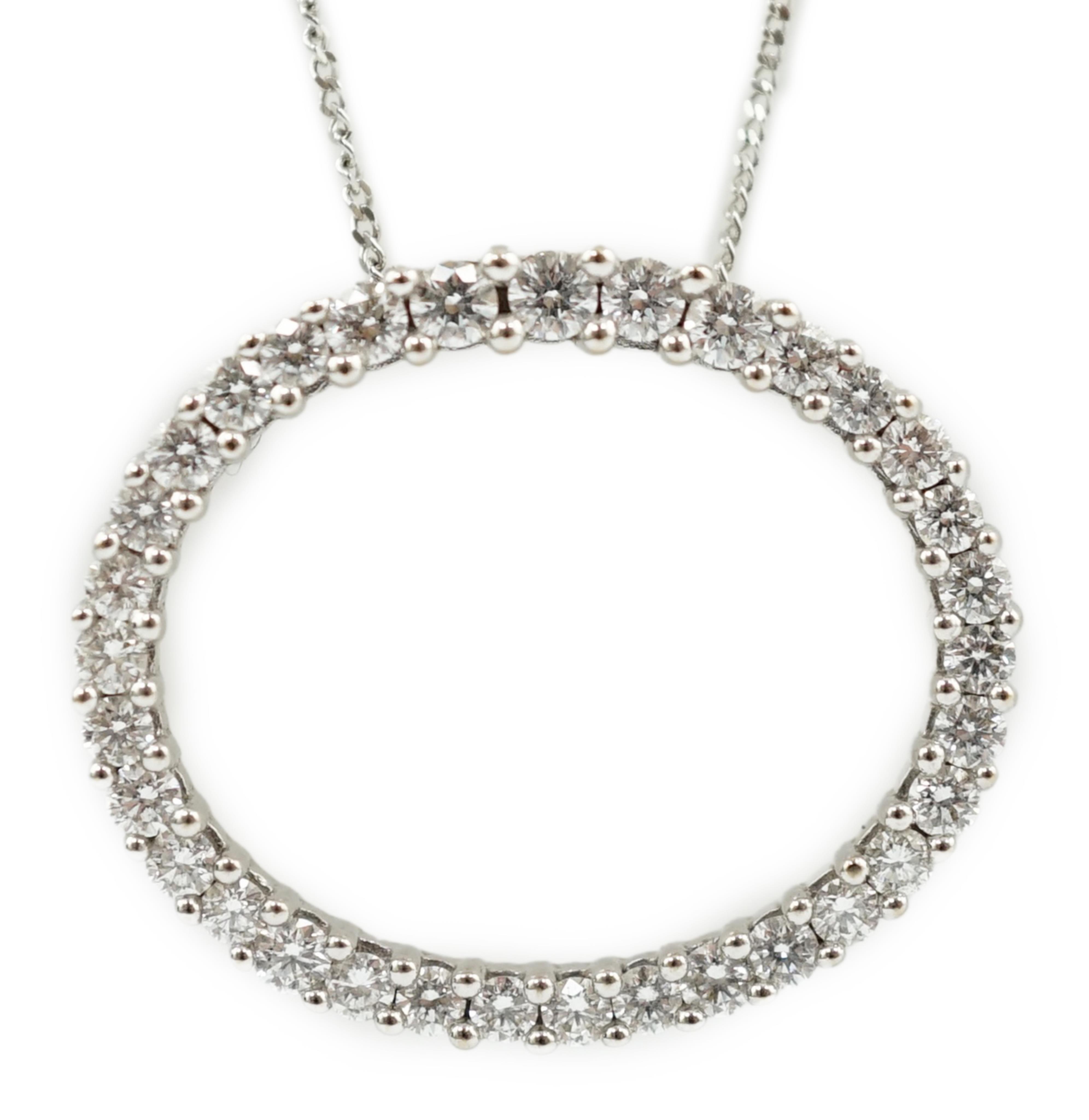 A modern 18k white gold and diamond cluster set open work oval pendant, on an Italian 18k white gold fine link chain